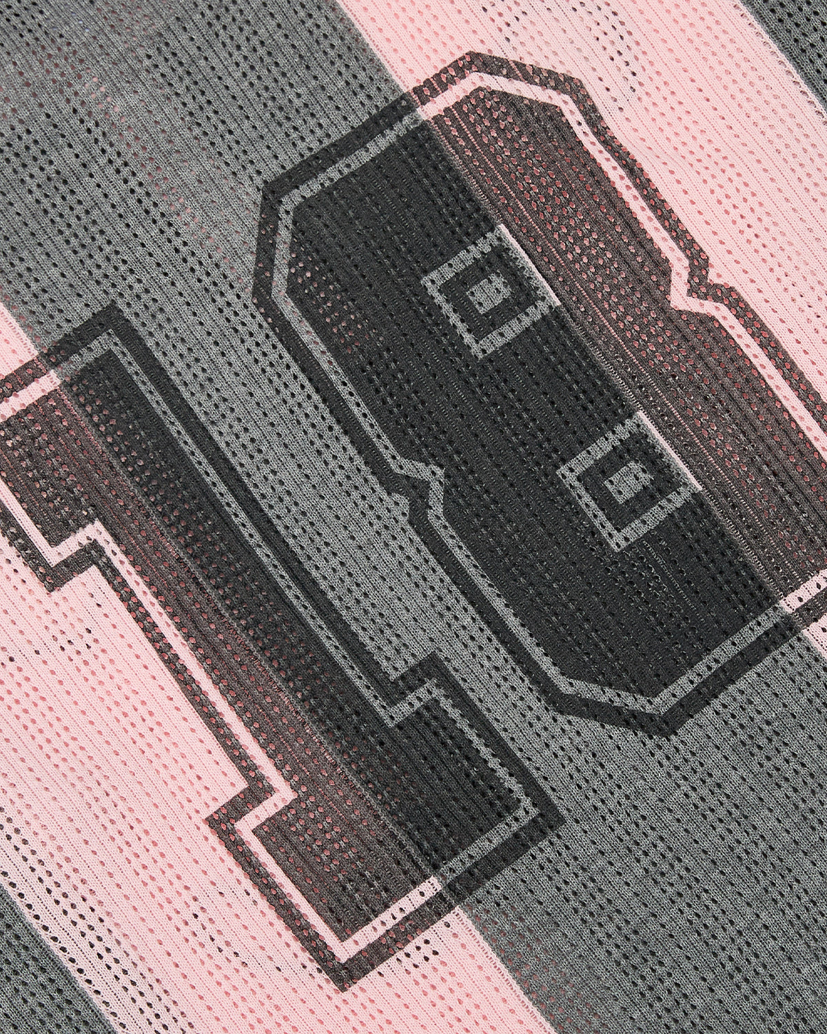 Close-up of Sundae School's PINK SUNDAE SOCCER JERSEY, showing perforated knit mesh with pink and gray stripes and a bold black-outlined number 18 printed on the fabric.