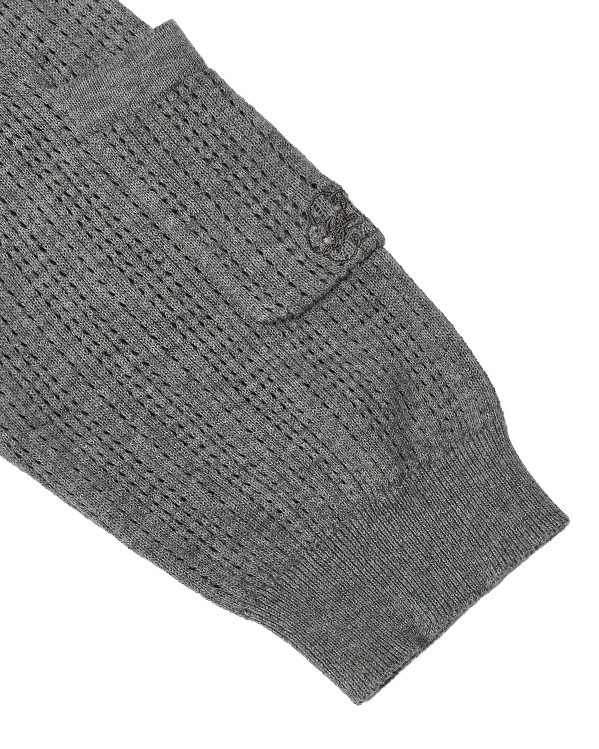 A close-up of the sleeve from the Sundae School PINK SUNDAE SOCCER JERSEY, featuring a textured, perforated knit pattern and a small pocket near the cuff, crafted from 100% cotton for a lightweight feel.