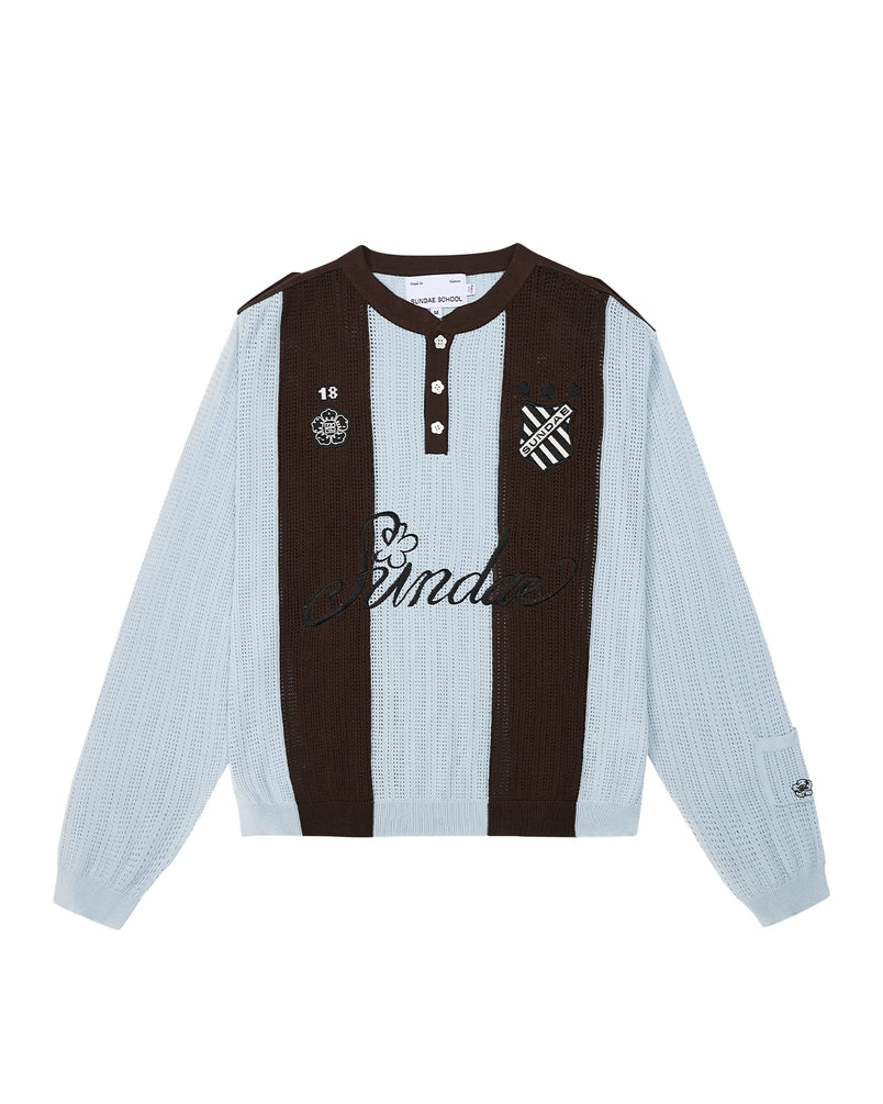 Sundae School SKY BLUE SUNDAE SOCCER JERSEY: This light blue and brown long-sleeve knit jersey features vertical stripes, a buttoned collar with unique floral mochi buttons, and embroidered chest patches—including a skull, heart, and “Banda” text—across the front.