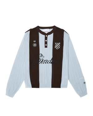 Sundae School SKY BLUE SUNDAE SOCCER JERSEY: This light blue and brown long-sleeve knit jersey features vertical stripes, a buttoned collar with unique floral mochi buttons, and embroidered chest patches—including a skull, heart, and “Banda” text—across the front.