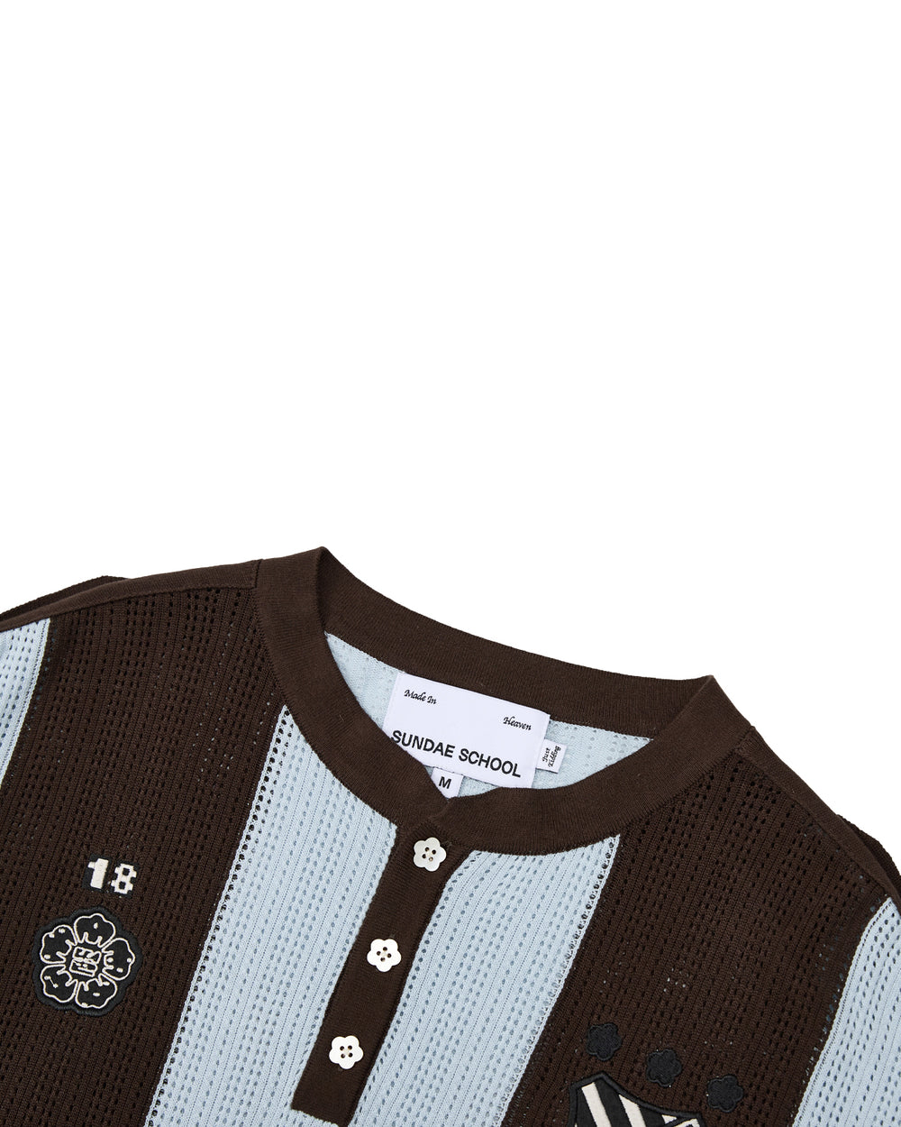 Introducing the SKY BLUE SUNDAE SOCCER JERSEY by Sundae School—a lightweight cotton knit shirt featuring brown and sky blue stripes, a round collar, floral mochi buttons, and embroidered chest patches including the number 18. Delicate floral embroidery and thoughtful detailing blend playful style with everyday comfort.