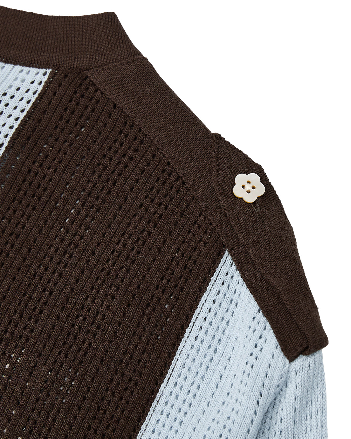 Close-up of the Sundae School SKY BLUE SUNDAE SOCCER JERSEY, featuring brown and light blue knitted stripes. A decorative cream-colored floral mochi button accents the brown shoulder panel.
