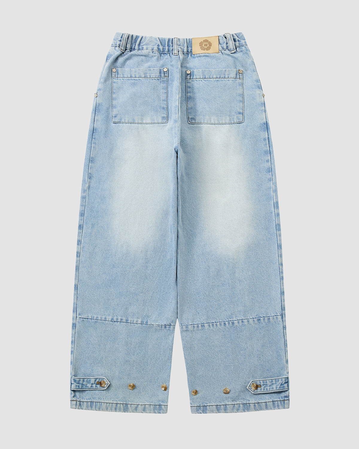 Sundae School’s SKY BLUE HANBOK DENIM PANTS are shown from the back, featuring two large rear pockets, adjustable waist tabs, buttoned hems, and a vintage light blue wash.