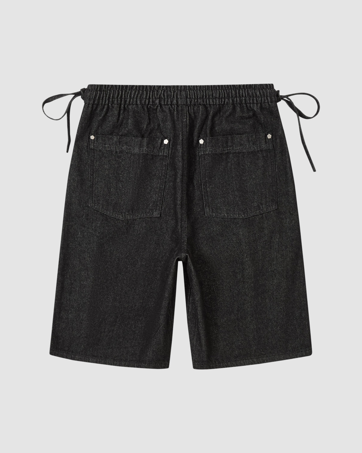 The BLACK VITA JORTS by Sundae School are black wide-leg denim shorts with an elastic waistband, side drawstrings, and two back pockets, shown laid flat on a light gray background.