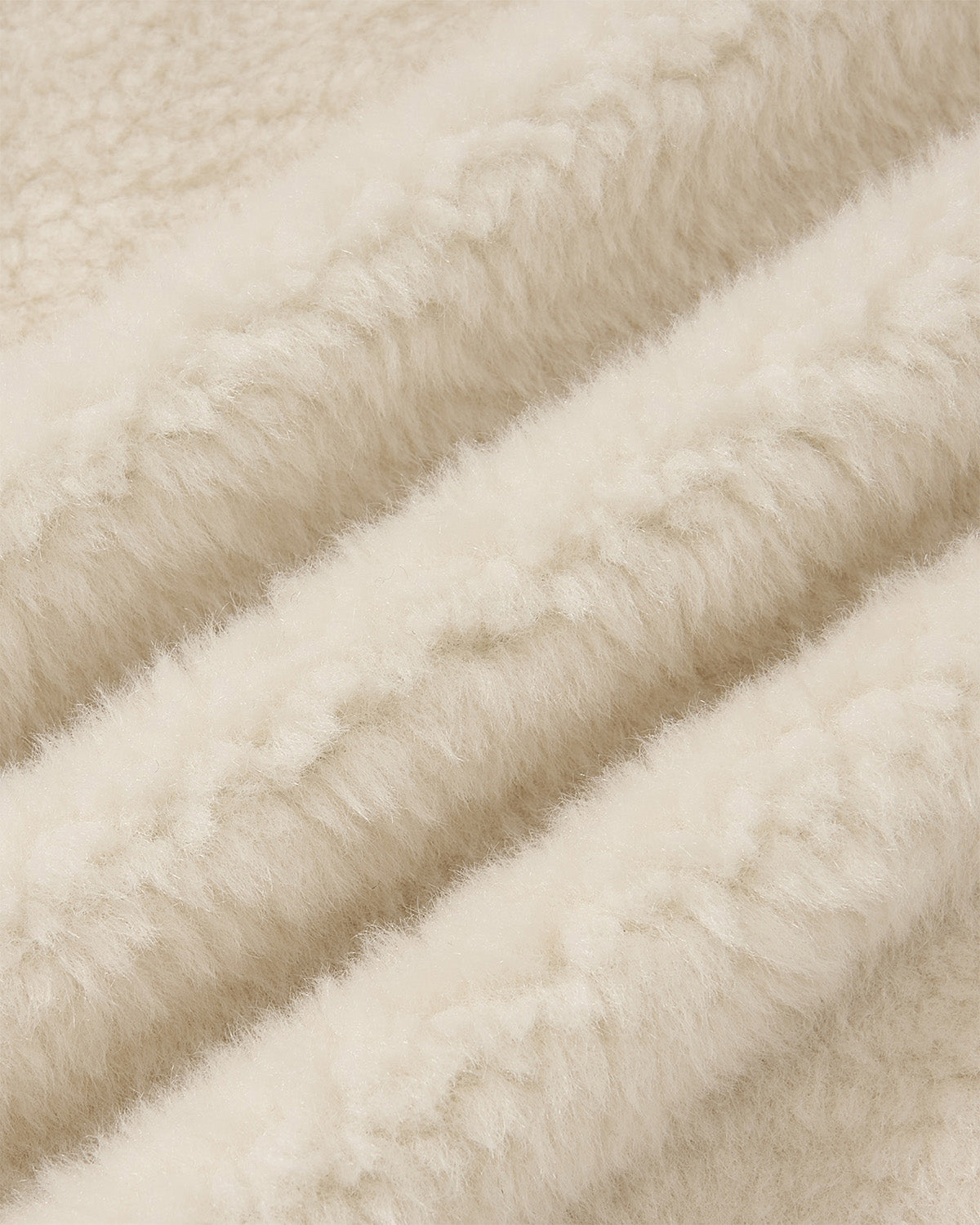 Close-up of Sundae School's IVORY MUGUNGHWA FLEECE, showcasing its soft, cream-colored jacquard fleece with a plush, sherpa-like texture and gentle folds.