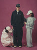 Two Korean lady taking measurements of a male model wearing Sundae School Flower Knot Zip Up Hoodie and the Wrap Sweatbaji