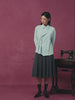 A WOMAN GLAZING INTO THE CAMERA WEARIING SUNDAE SCHOOL SKY BLUE TIE GORUM SHIRT