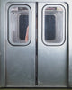 Wearing Sundae School's MEDIUM BLUE FRESHMAN FIT DENIM, a person stands by subway doors with a crowd rushing in.