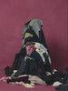 A slow motion of a piles of fabric being lifted off of a woman wearing SUNDAE SCHOOL ASYMMETRIC WORK JACKET