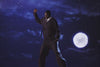 A video of a man jumping into the night sky wearing Sundae School Navy Hanbok Tie Blazer and Navy Hanbok Balloon Pants