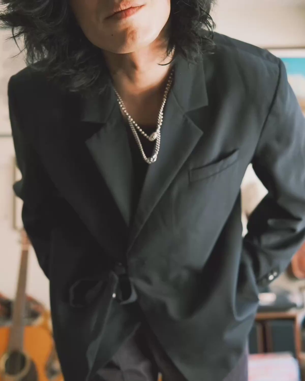 A streetwear lookbook video featuring a man styling Korean-inspired outfits from Sundae School. He demonstrates multiple versatile looks in a sunlit room, combining a black Hanbok-style tie blazer and wide-leg trousers with ribbed tank tops, plaid flannel shirts, denim button-ups, and white tees.